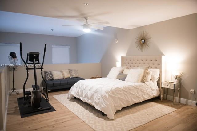 8395 Southwest 73rd Avenue, Unit 105 Miami, FL 33143 - Photo 9 of 14 a bedroom with a bed and a mirror