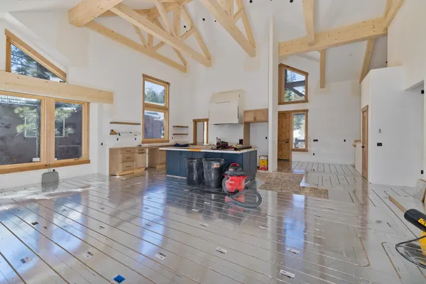 a kitchen that has a sink a stove and wooden cabinets