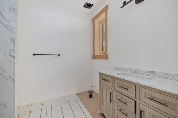 a view of a room with wooden floor and shower