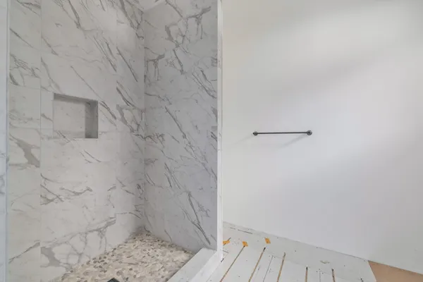 a bathroom with a granite countertop sink a toilet and shower
