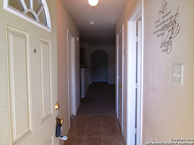 10003 Vasso View, Unit 4 Converse, TX 78109 - Photo 2 of 10 a view of a hallway with wooden shelves