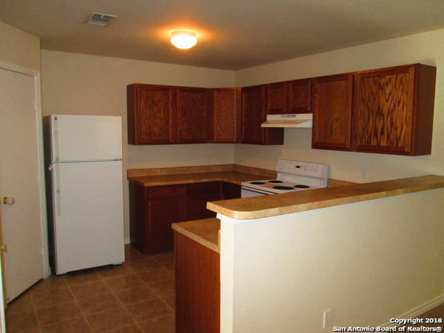 10003 Vasso View, Unit 4 Converse, TX 78109 - Photo 5 of 10 a kitchen with a sink and a refrigerator