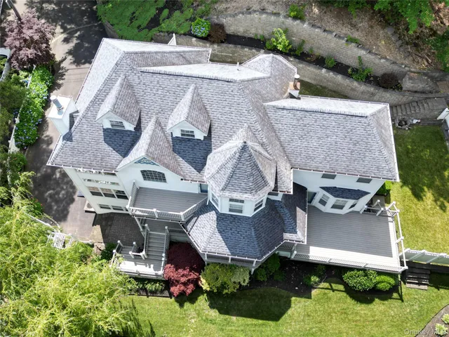 an aerial view of residential houses with outdoor space and parking