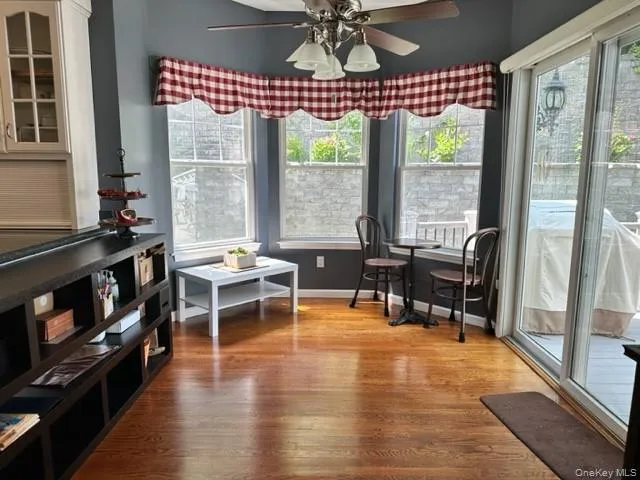 a living room with furniture a fireplace and a floor to ceiling window