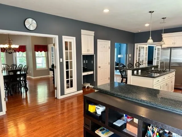 a kitchen with stainless steel appliances granite countertop a stove and cabinets