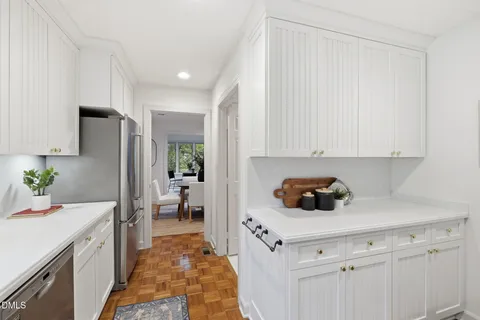 a kitchen with a sink and refrigerator