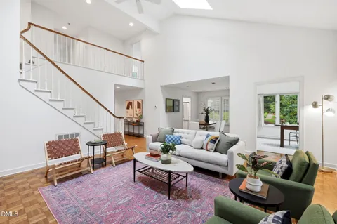 a living room with furniture wooden floor and a table