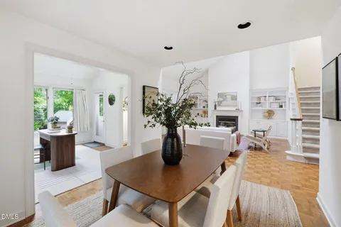 a dining room with furniture a window and a fireplace