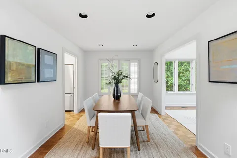 a dining room with furniture and wooden floor