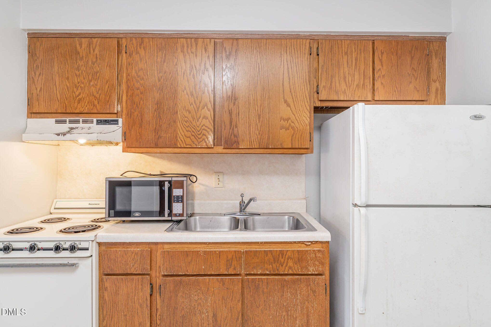 4700 Westgrove Street, Unit 216 Raleigh, NC 27606 - Photo 10 of 21 a kitchen with stainless steel appliances granite countertop a refrigerator a stove a sink and white cabinets