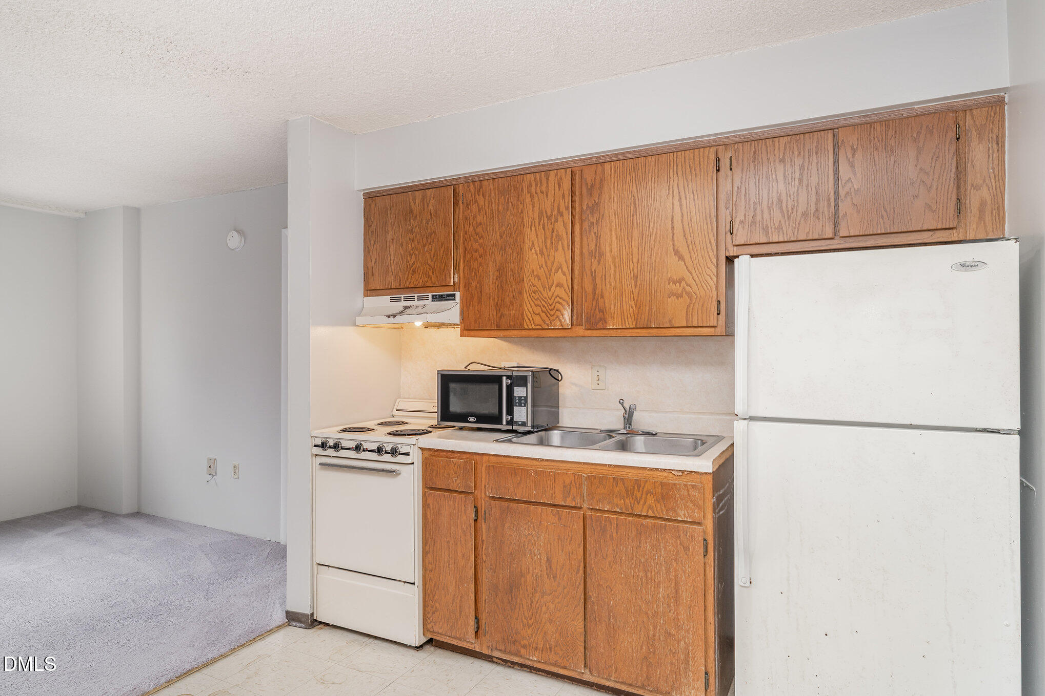 4700 Westgrove Street, Unit 216 Raleigh, NC 27606 - Photo 11 of 21 a kitchen with stainless steel appliances granite countertop a refrigerator sink stove and cabinets