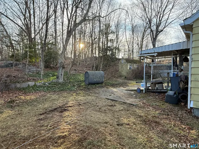 a view of a chairs and table in the backyard