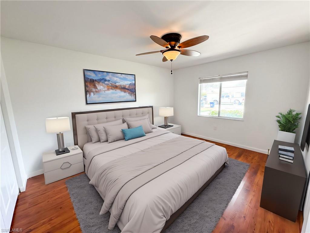 18584 Sebring Road Fort Myers, FL 33967 - Photo 13 of 25 Bedroom with ceiling fan and wood-type flooring. This photo has been virtually staged.