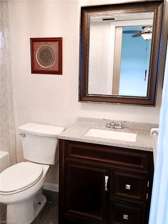 18584 Sebring Road Fort Myers, FL 33967 - Photo 15 of 25 Bathroom with ceiling fan, vanity, and toilet