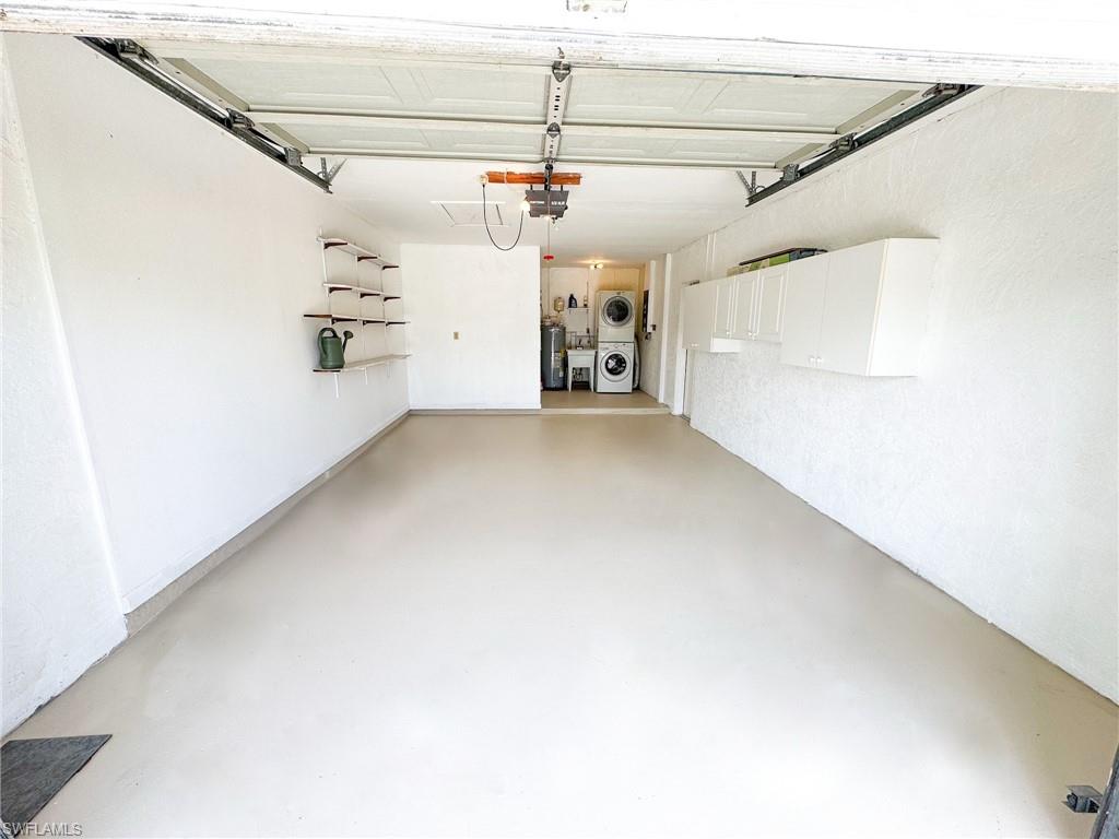 18584 Sebring Road Fort Myers, FL 33967 - Photo 19 of 25 Garage featuring a garage door opener and washer and clothes dryer