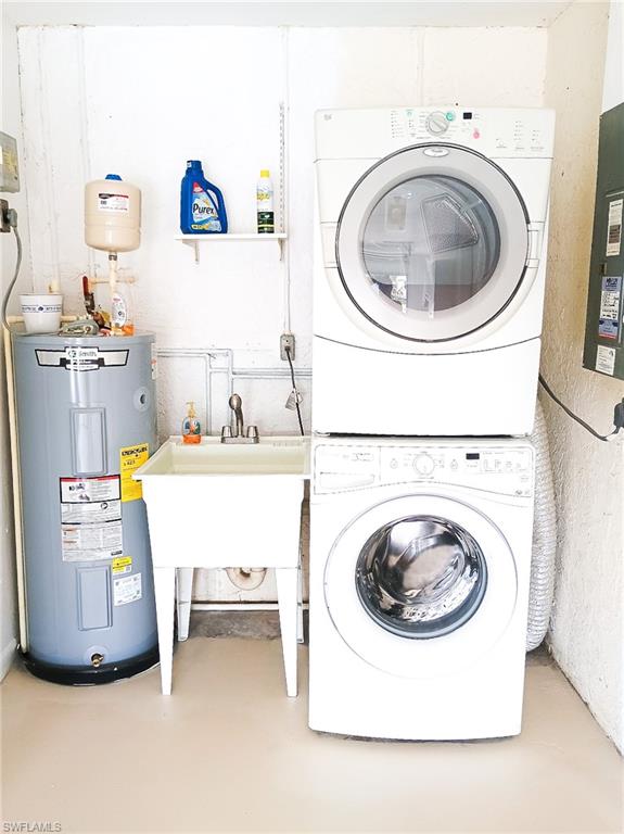 18584 Sebring Road Fort Myers, FL 33967 - Photo 20 of 25 Laundry area featuring stacked washer / dryer, electric water heater, and sink