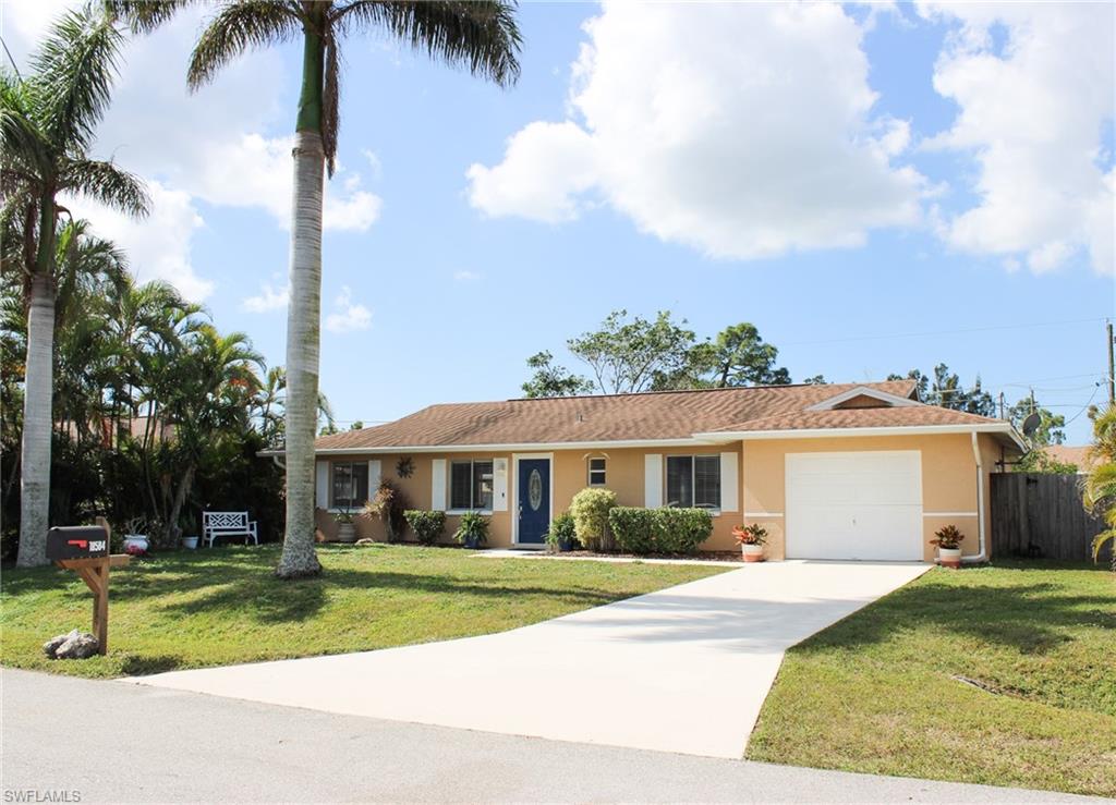 18584 Sebring Road Fort Myers, FL 33967 - Photo 2 of 25 Single story home with a garage and a front yard