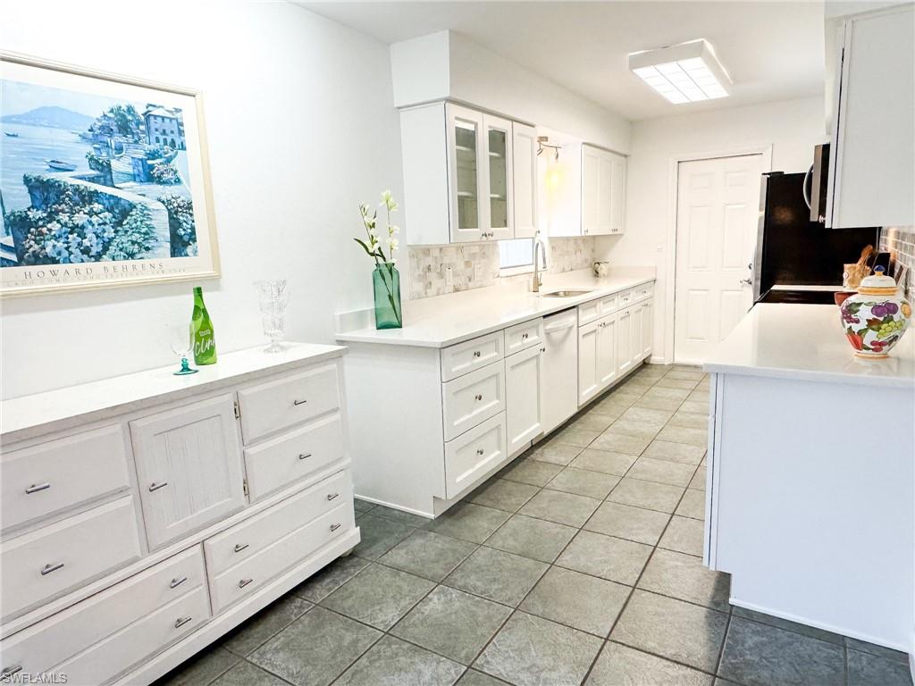 18584 Sebring Road Fort Myers, FL 33967 - Photo 5 of 25 Kitchen with dishwasher, sink, white cabinets, and decorative backsplash