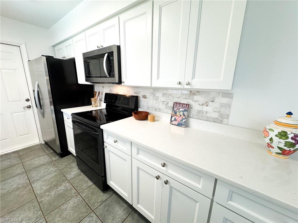 18584 Sebring Road Fort Myers, FL 33967 - Photo 7 of 25 Kitchen featuring white cabinetry.