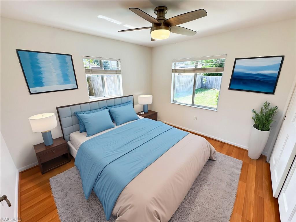 18584 Sebring Road Fort Myers, FL 33967 - Photo 10 of 25 Bedroom with multiple windows, ceiling fan, and light wood-type flooring. This photo has been virtually staged.