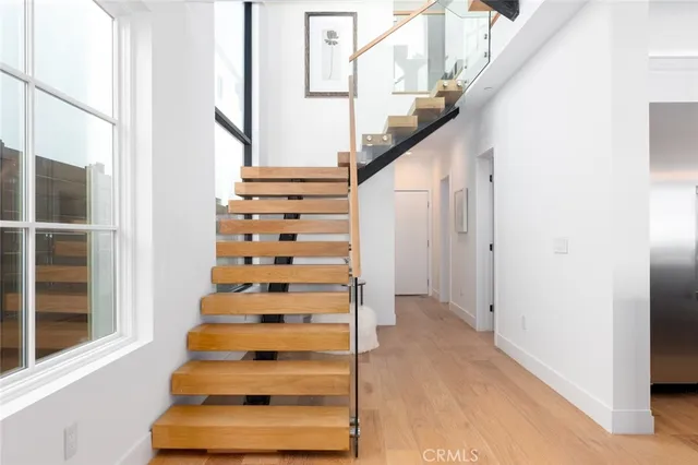 a living room with furniture kitchen view and a large window