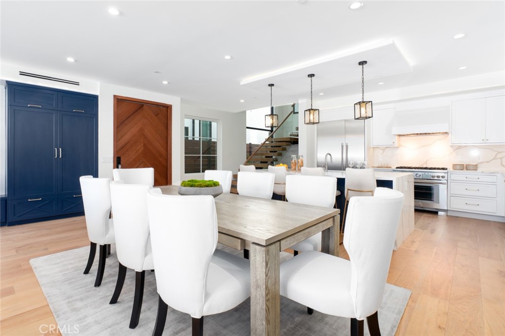 1025 West Balboa Boulevard Newport Beach, CA 92661 - Photo 13 of 70 a view of a dining room with furniture and wooden floor