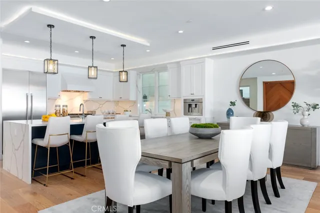 a kitchen with a stove a table and chairs