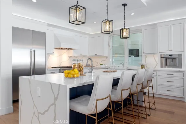 a kitchen with granite countertop a stove and a white cabinets