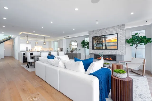 a living room with furniture a large window and a dining table