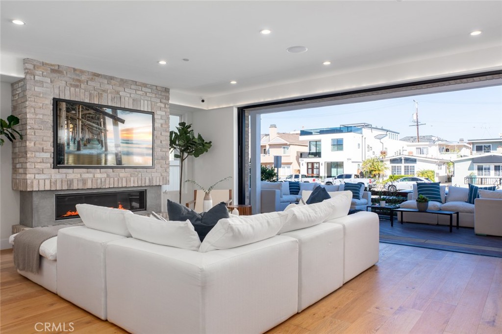 1025 West Balboa Boulevard Newport Beach, CA 92661 - Photo 18 of 70 a living room with furniture fireplace and large windows