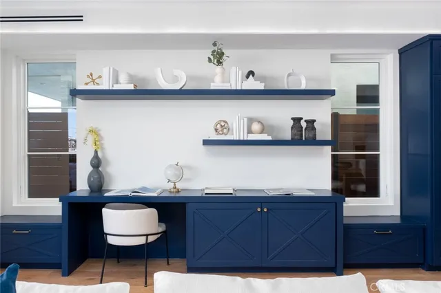 a spacious bedroom with a bed and a dresser with mirror