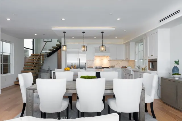 a living room with chairs and stairs