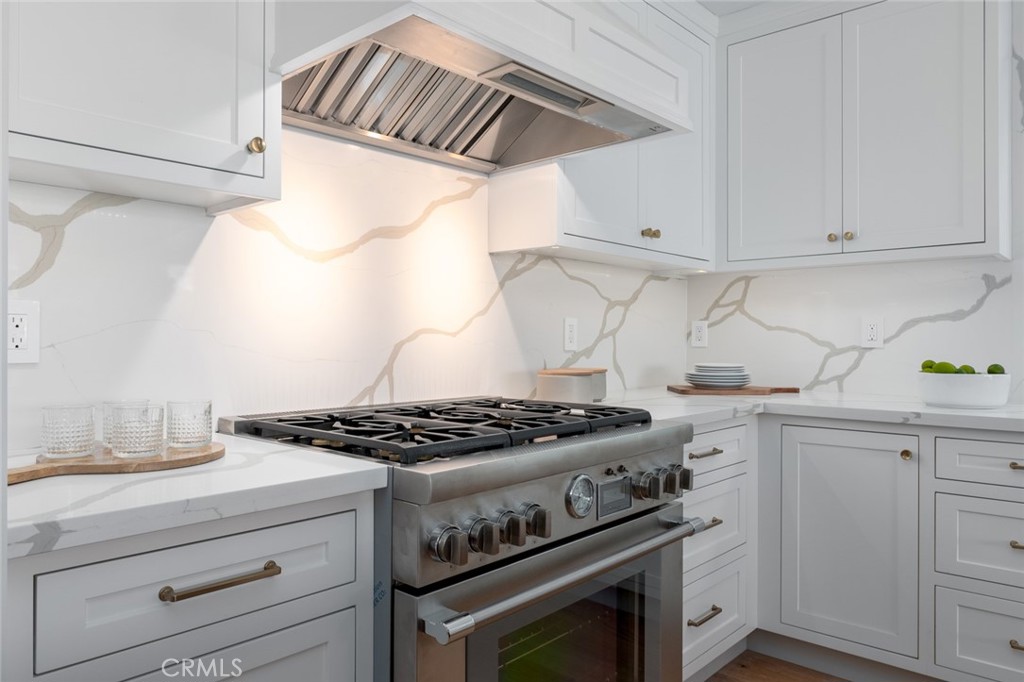 1025 West Balboa Boulevard Newport Beach, CA 92661 - Photo 25 of 70 a kitchen with granite countertop a stove and a white cabinets