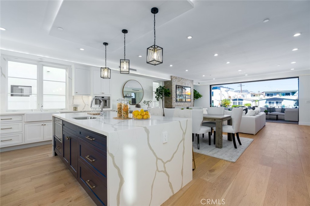 1025 West Balboa Boulevard Newport Beach, CA 92661 - Photo 26 of 70 a kitchen with a sink a counter space appliances and a center island