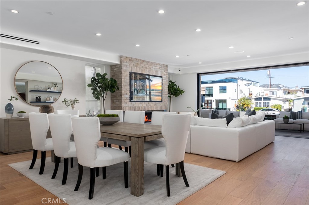 1025 West Balboa Boulevard Newport Beach, CA 92661 - Photo 27 of 70 a living room with furniture a large window and a dining table