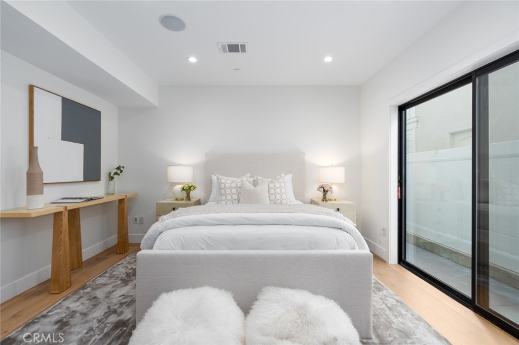 1025 West Balboa Boulevard Newport Beach, CA 92661 - Photo 31 of 70 a spacious bedroom with a bed and a dresser with mirror