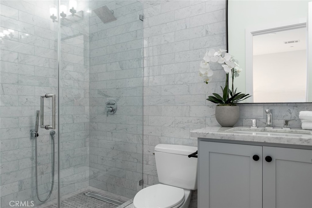 1025 West Balboa Boulevard Newport Beach, CA 92661 - Photo 33 of 70 a bathroom with a granite countertop sink a toilet and shower