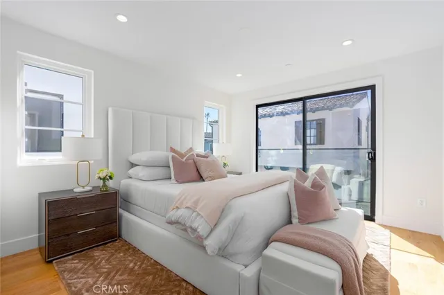 a large bedroom with a large bed and a large window