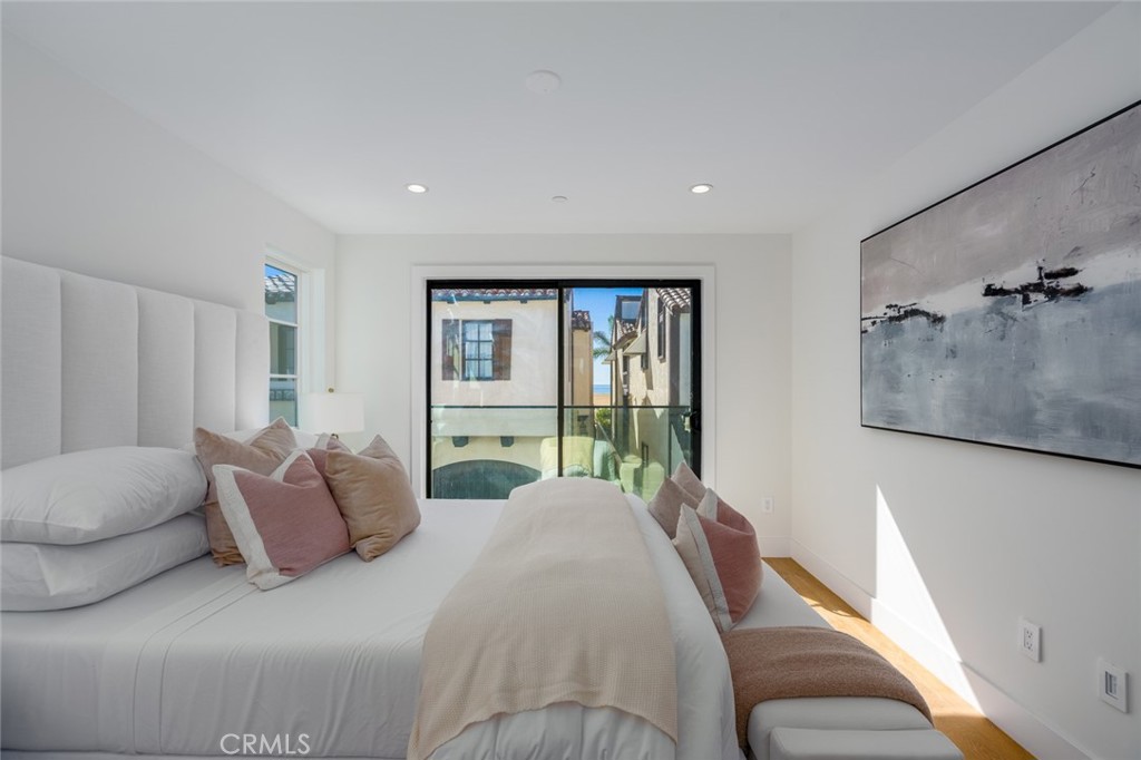1025 West Balboa Boulevard Newport Beach, CA 92661 - Photo 35 of 70 a bedroom with a balcony a bed and a couch