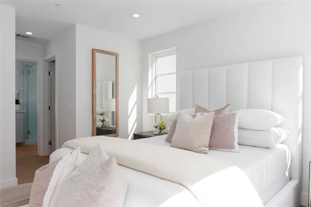 a spacious bedroom with a bed and couch