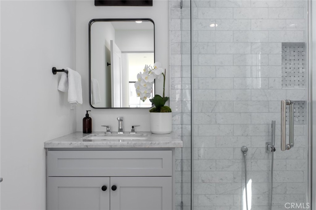 1025 West Balboa Boulevard Newport Beach, CA 92661 - Photo 38 of 70 a bathroom with a double vanity sink and a mirror