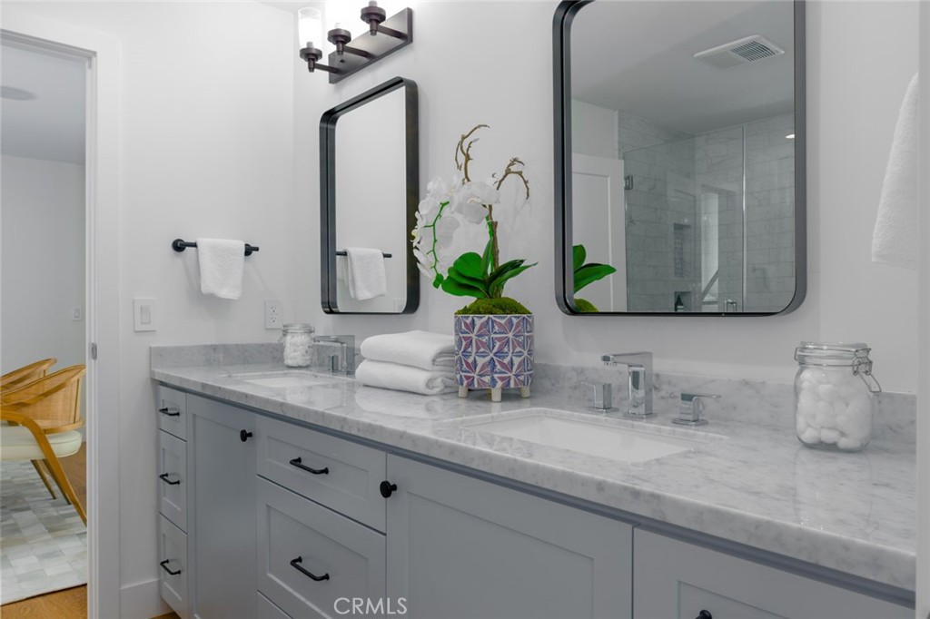 1025 West Balboa Boulevard Newport Beach, CA 92661 - Photo 48 of 70 a bathroom with double vanity sinks and a mirror