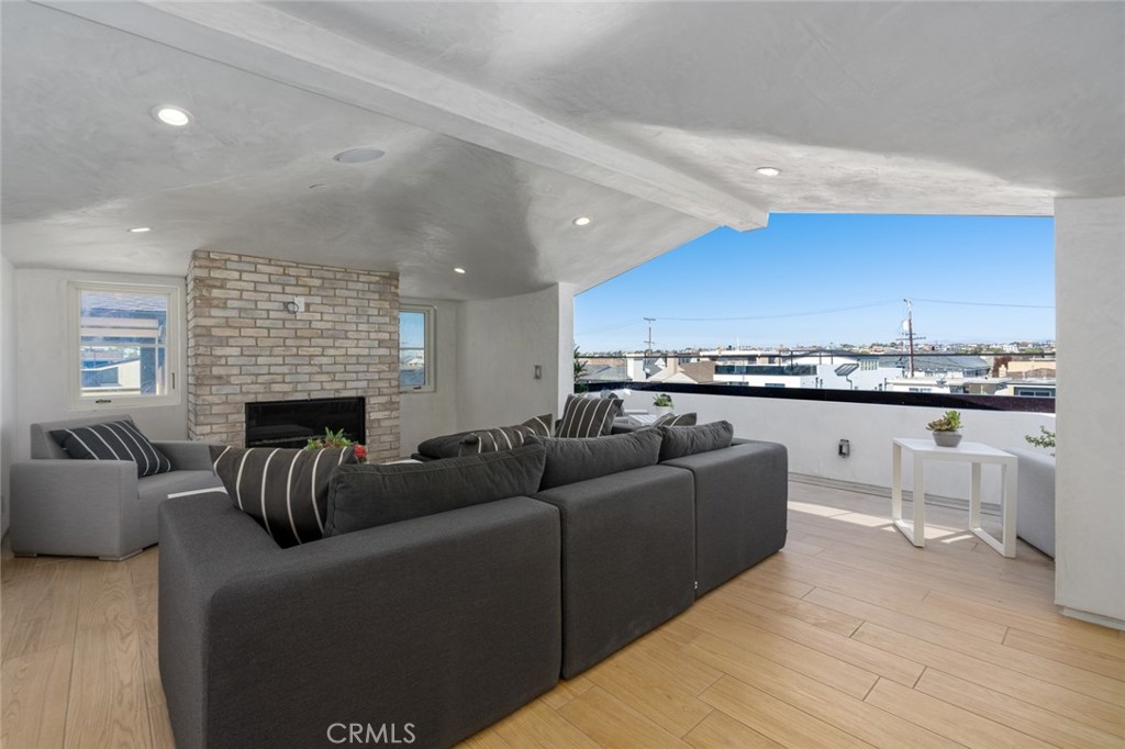 1025 West Balboa Boulevard Newport Beach, CA 92661 - Photo 68 of 70 a living room with furniture a fireplace and kitchen view