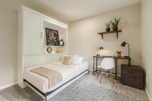 a bedroom with a bed and a table in it