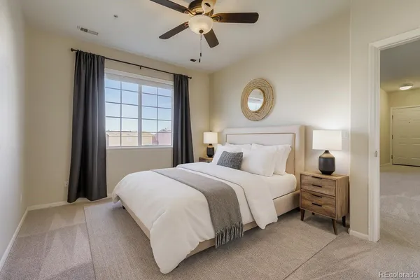 a bedroom with a bed and a window