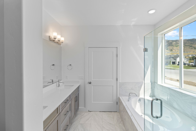 657 North 200 East Providence, UT 84332 - Photo 6 of 10 While design finishes differ, the bathroom features a soaker tub and a spacious walk-in shower.