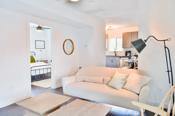 a living room with furniture and a wooden floor