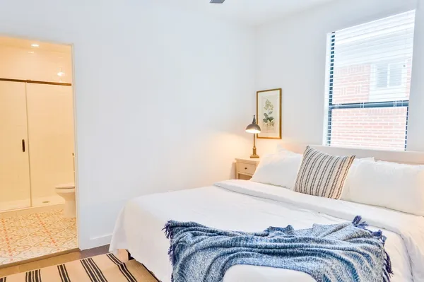 a bedroom with a bed and wooden floor