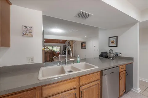 a kitchen with sink and mirror