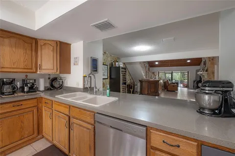 a kitchen with stainless steel appliances a sink stove and cabinets